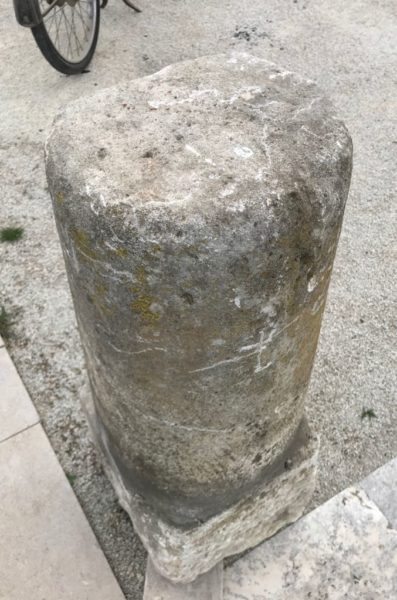 row of antique granite driveway posts